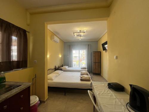 a room with two beds and a window in it at Hermes Studio in Paralia Katerinis