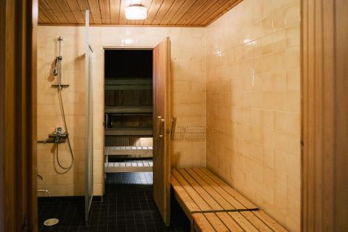 a bathroom with a shower and a walk in shower at Näsby apartment with sauna in Houtskari