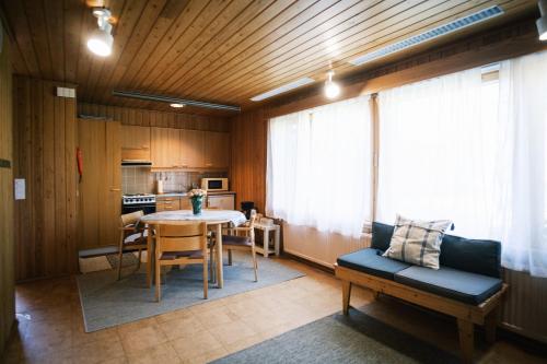 a living room with a table and a kitchen at Näsby apartment with sauna in Houtskari