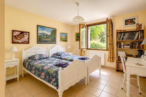 a bedroom with a white bed and a window at Villa Tromelin in Bouc-Bel-Air