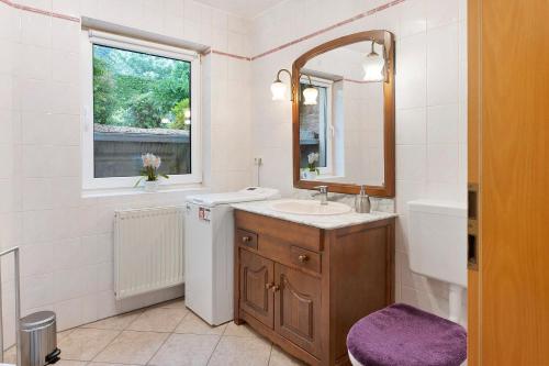 a white bathroom with a sink and a mirror at Ferienwohnung sehr ruhig in Pößneck