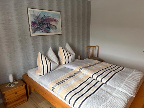 a bed in a bedroom with a picture on the wall at Roxy in Beverungen