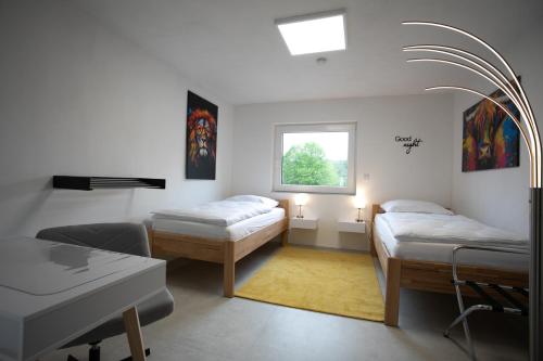 a hospital room with two beds and a window at Walters Weidelbach in Haiger