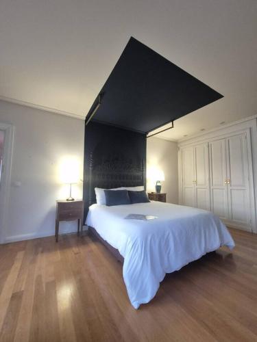 a bedroom with a large bed with a black headboard at Oia Mar & Relax in Oya