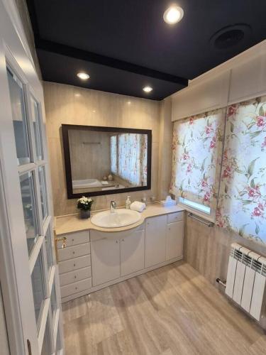 a bathroom with a sink and a mirror at Oia Mar & Relax in Oya
