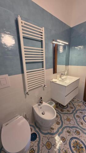 a bathroom with a toilet and a sink at Seaview Home Bacoli in Bacoli