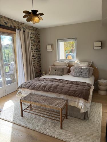 a bedroom with a large bed and a ceiling fan at Maison Maün in Gelos