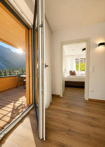 a living room with a view of a bedroom at Alpenstolz Damüls Haus 4 - Stilvoll urlauben in den Bergen in Damuls