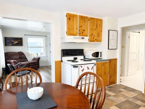 a kitchen and dining room with a table and chairs at Gus & Nellie's Place in Twillingate