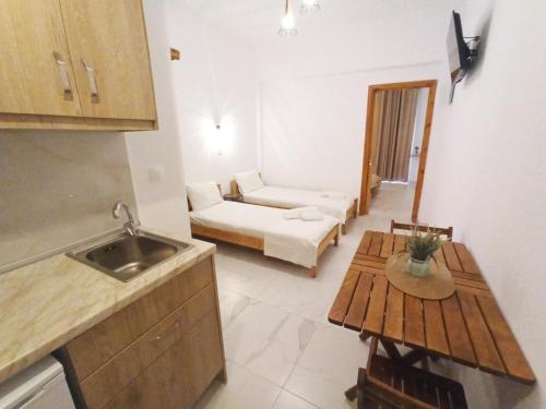 a kitchen and living room with a couch and a table at Elena Apartments in Keramoti
