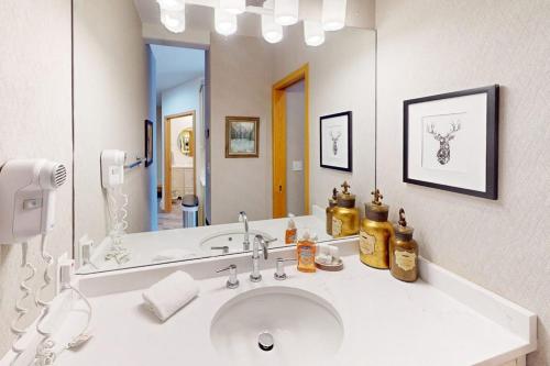 a bathroom with a sink and a large mirror at River Bank Lodge 2924 in Keystone