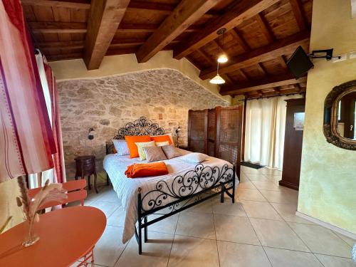 a bedroom with a bed with orange pillows on it at La Cascina della Vachina in Poggio Bustone