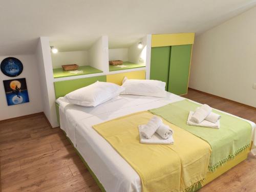a bedroom with a large bed with towels on it at Green Lagoon, Hvar island in Vrboska