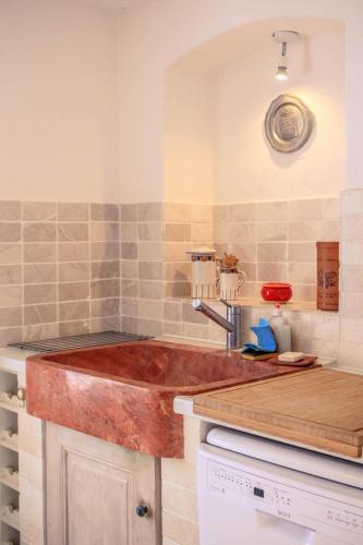 a kitchen with a wooden counter top and a sink at La bastide d'emilie sud est in Saint Antonin du Var