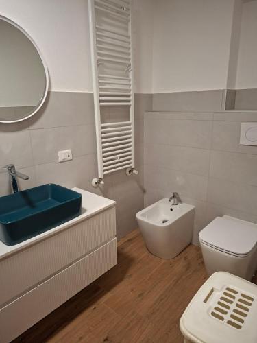 a bathroom with a blue sink and a toilet at La Casa di Mimma in Badolato