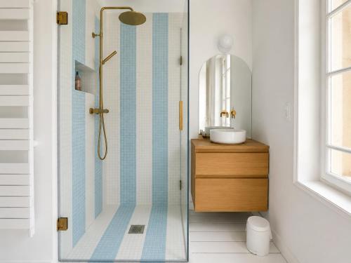 a bathroom with a shower with a sink and a mirror at Villa La Rafale plage centre 300 m in Le Touquet-Paris-Plage