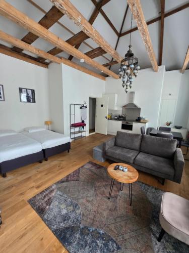 a living room with a couch and a table at Barbera Guesthouse Hotel Apartments - Experience local life in the Old Centre in Haarlem
