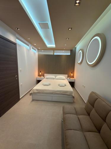 a bedroom with a bed and a couch at Lux In A Box, Apartments In the center in Nea Kallikrateia
