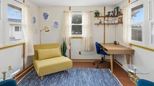 a living room with a desk and a chair at Cape Bay Cottage in North Cape May