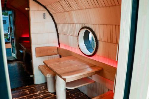 a bench and a mirror in a tiny house at ''Zunds'' Camping house in Riga