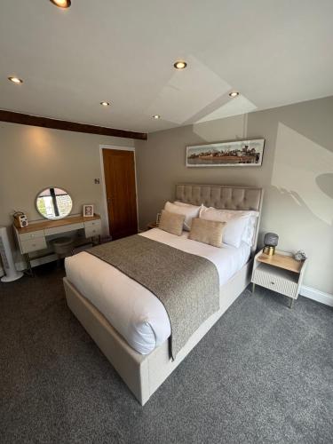 a bedroom with a large white bed and a window at Small and Snug The Old Store in Broadstairs