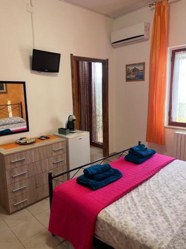 a bedroom with a bed with two blue towels on it at Dream Beach Salento in Porto Cesareo