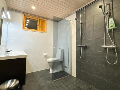 a bathroom with a shower and a toilet and a sink at Par 10 in Tahkovuori