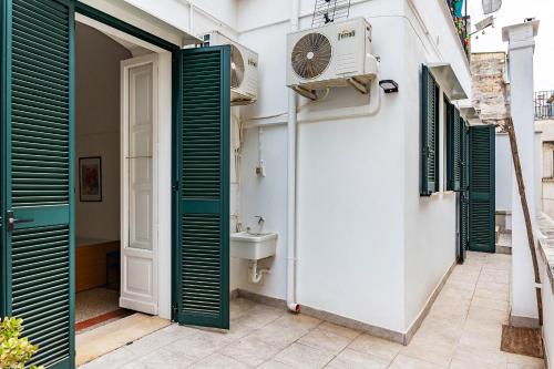 a bathroom with a sink and a clock on the wall at 15min Polignano Puglia Historical Center Terrace in Conversano