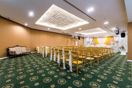 a room with rows of chairs and a room with a stage at Buri Sriphu Hotel in Hat Yai