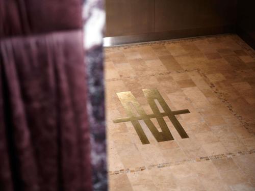 a shadow of a cross on a tile floor at Hotel Morris Sydney, Handwritten Collection in Sydney