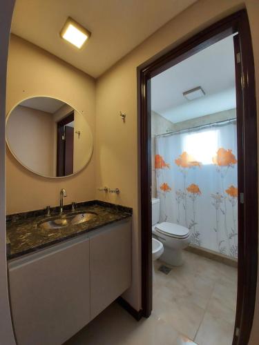 a bathroom with a sink and a toilet and a mirror at Veneto Village in Villa Parque Siquiman