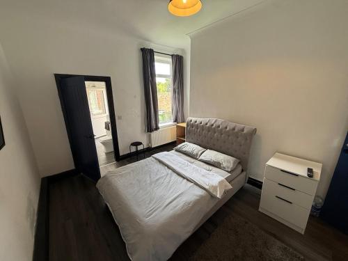 a bedroom with a bed and a mirror and a window at Plessey Road LARGE 5 Bed, 2 Bath, Contractors NEW in Cowpen