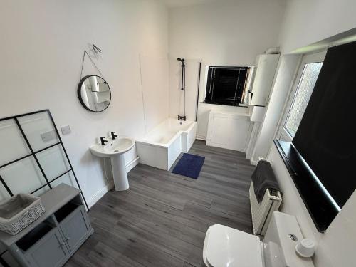 a white bathroom with a sink and a mirror at Plessey Road LARGE 5 Bed, 2 Bath, Contractors NEW in Cowpen