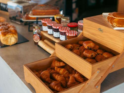 two wooden boxes filled with different types of bread at ibis Styles La Rochelle Centre Gare in La Rochelle