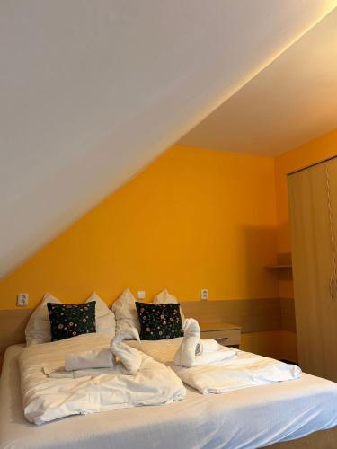 a bed with towels on it in a room at Apartman Nina in Kvačany