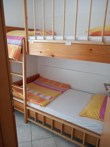 a couple of bunk beds in a room at Apartmani Lalu in Rtina
