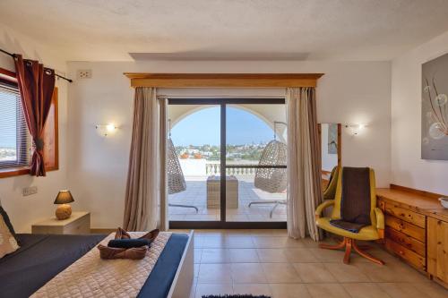 a bedroom with a bed and a view of a balcony at D View 4 You in Mellieħa