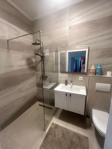 a bathroom with a sink and a shower and a toilet at Nous Cafe & Restaurant in Krumnussbaum