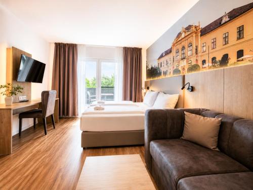 a hotel room with a bed and a couch at Hotel Sachsengang - free parking, near U1 & U2 in Groß-Enzersdorf