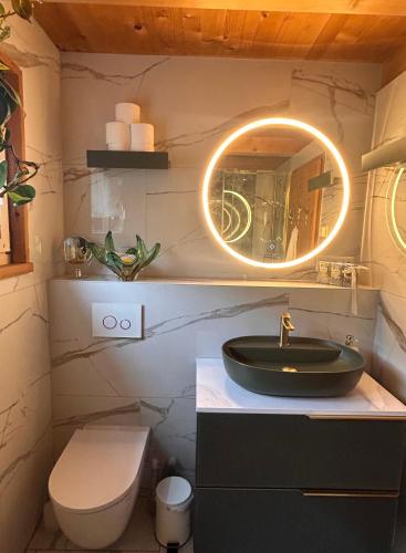 a bathroom with a sink and a mirror at Ursulas BnB Hemberg View in Hemberg