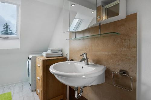 a bathroom with a white sink and a window at Ferienwohnung 1 in Gribow