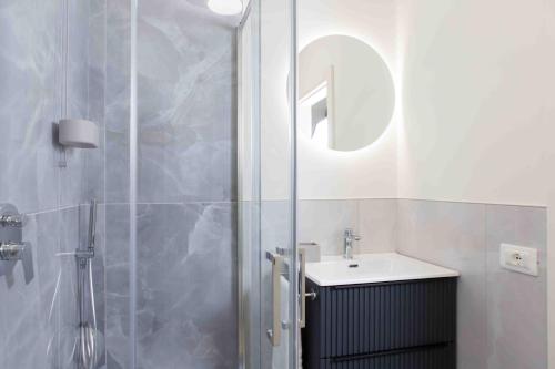a bathroom with a shower and a sink at La Ruota Rooms in Casalgrande