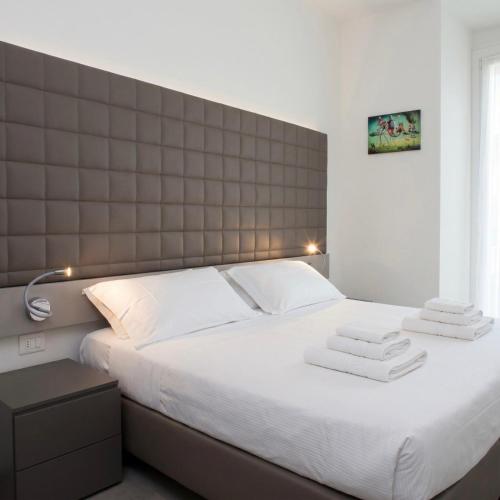 a bedroom with a large bed with towels on it at La Ruota Rooms in Casalgrande