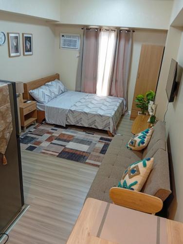 a small room with a bed and a couch at Avida Towers Riala, Tower 5 in Cebu City