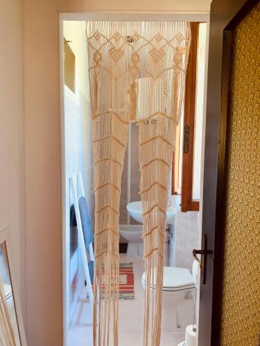 a door with a curtain in a room at Nùi Homestay in Monastero di Lanzo
