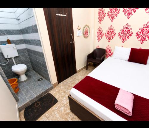 a bedroom with a bed and a shower and a toilet at Trip Kashi Guest House in Varanasi