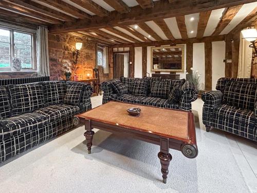 a living room with couches and a coffee table at Ye Olde Stone House in Sutton Coldfield