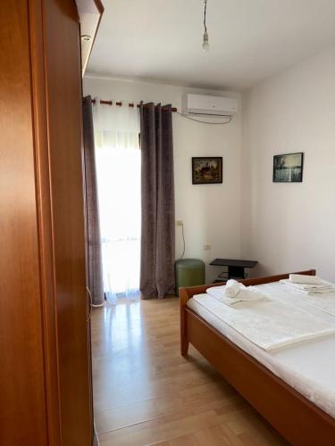 a bedroom with a bed and a large window at Hill Haven Guesthouse in Domje