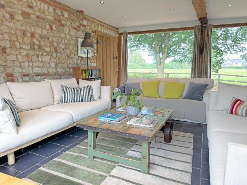 a living room with couches and a coffee table at The Granary in Oxborough