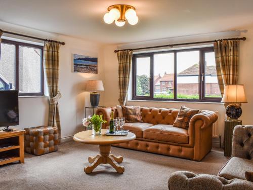 a living room with a couch and a table at Evergreen House in Runswick